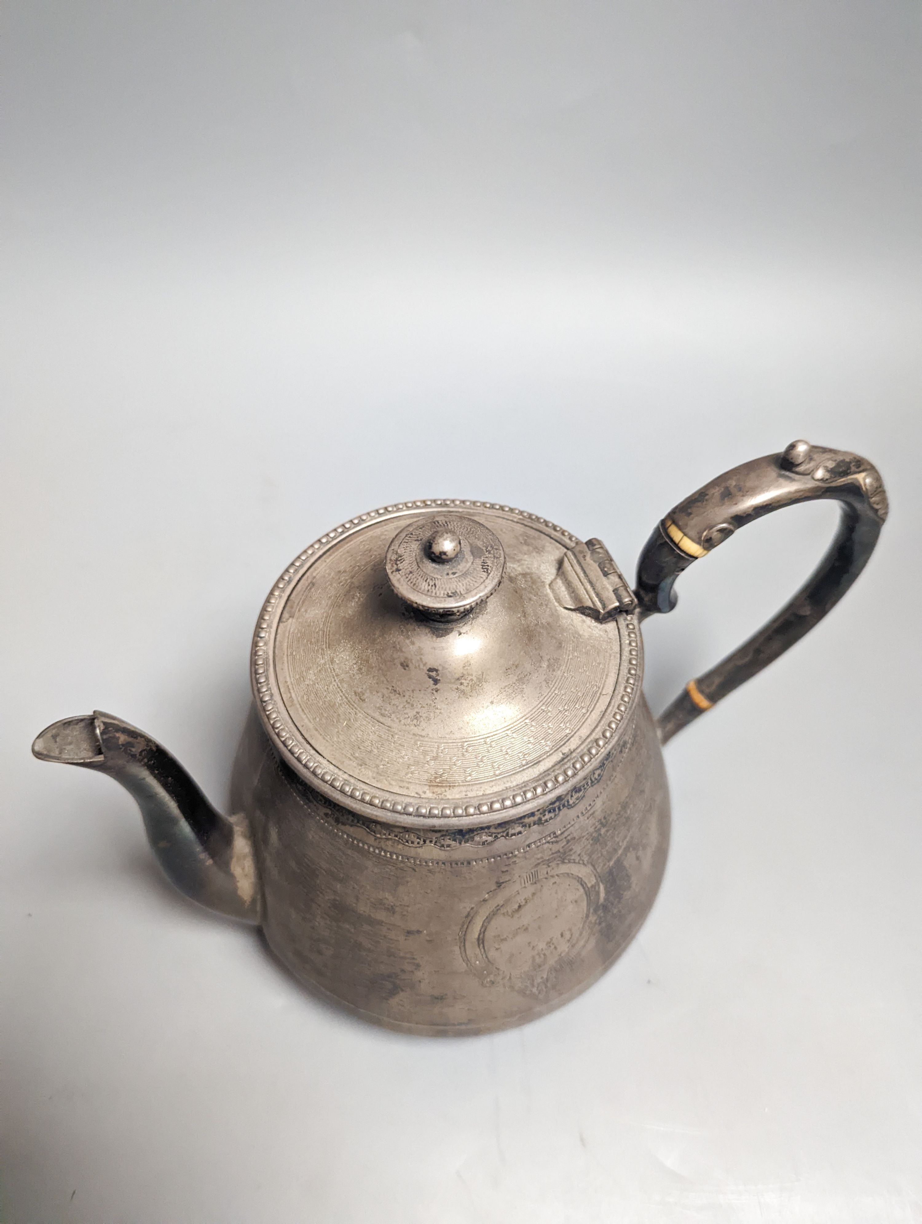 A Victorian engraved silver teapot, by Robert Hennell III, London, 1864, gross weight 19oz.